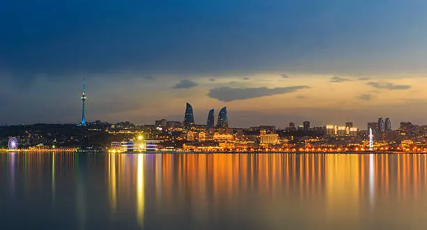 Baku skyline reflected in the Caspian Sea at night