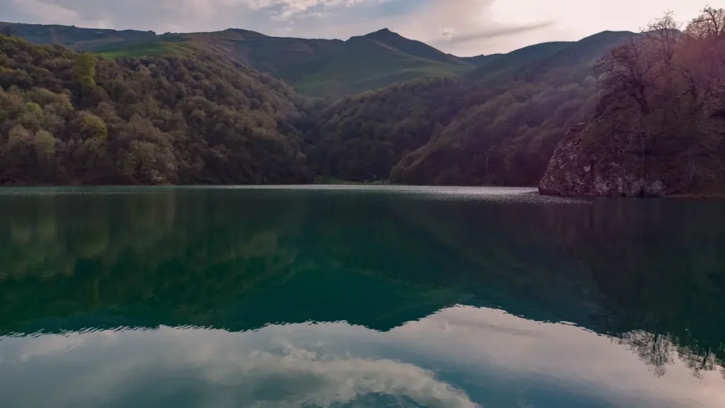 Lake Maralgol reflecting the mountains and forests of Goygol National Park